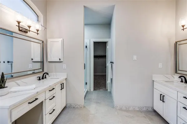 a bathroom with double sink and a mirror