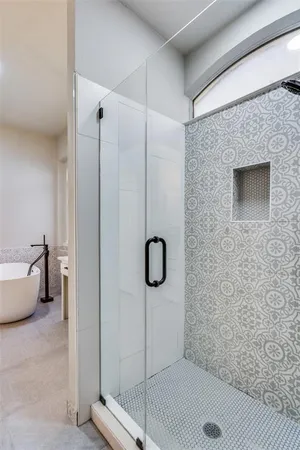 a bathroom with a tub and a shower