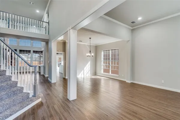 a view of interior space with wooden floor and staircase