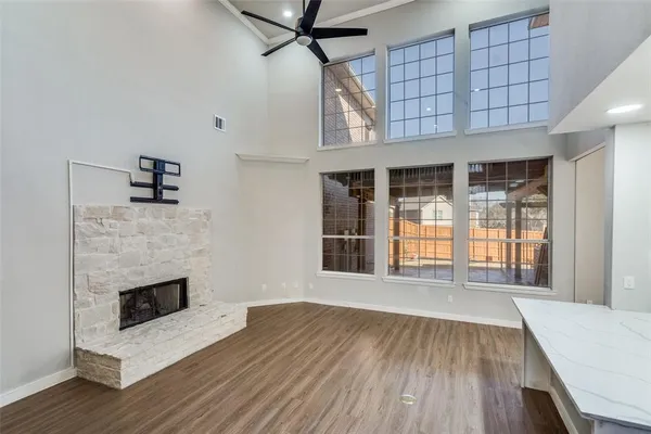 a view of a livingroom with wooden floor and a fireplace