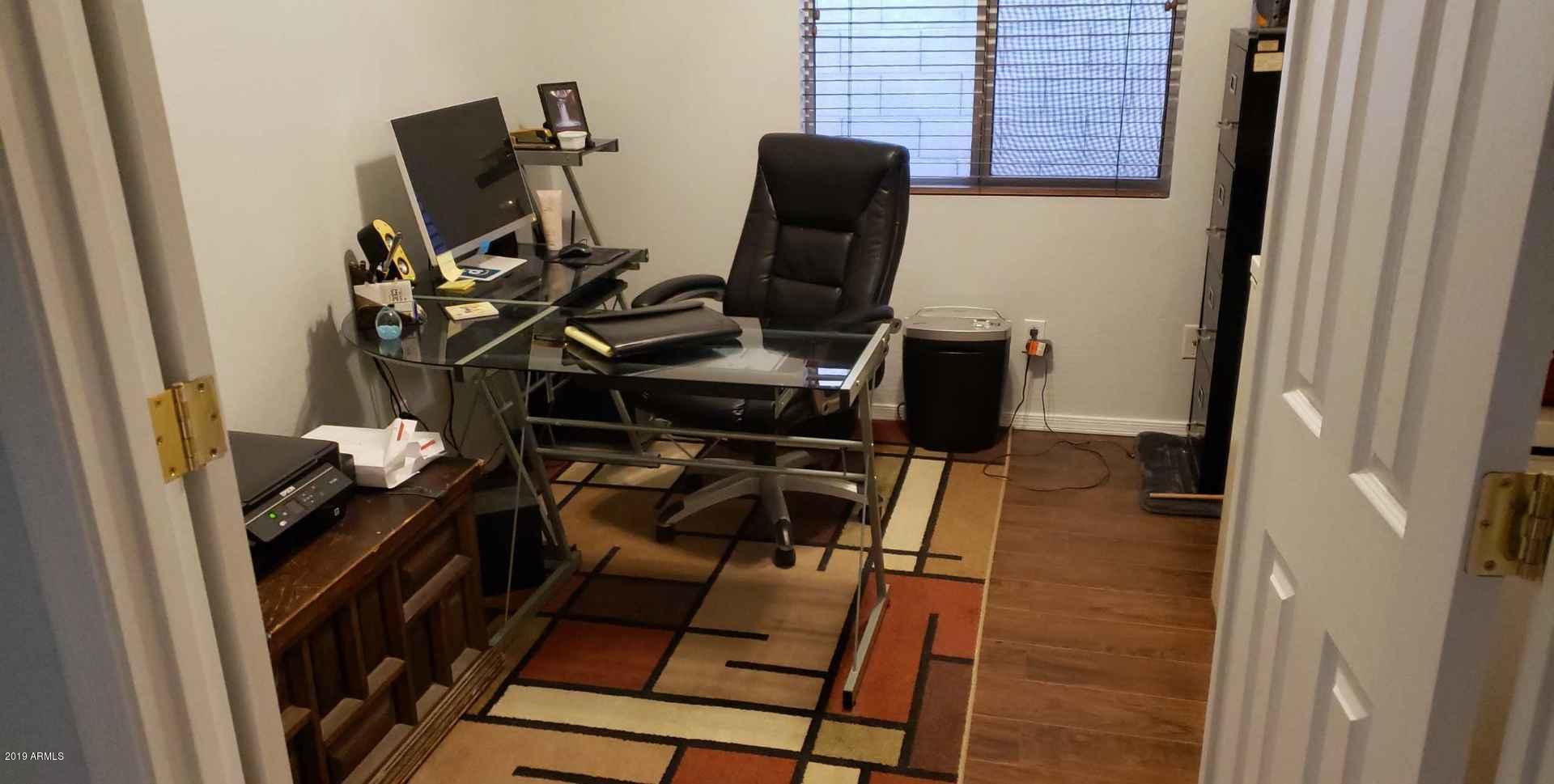 15801 West Redfield Road Surprise, AZ 85379 - Photo 11 of 26 a view of workspace with wooden floor windows