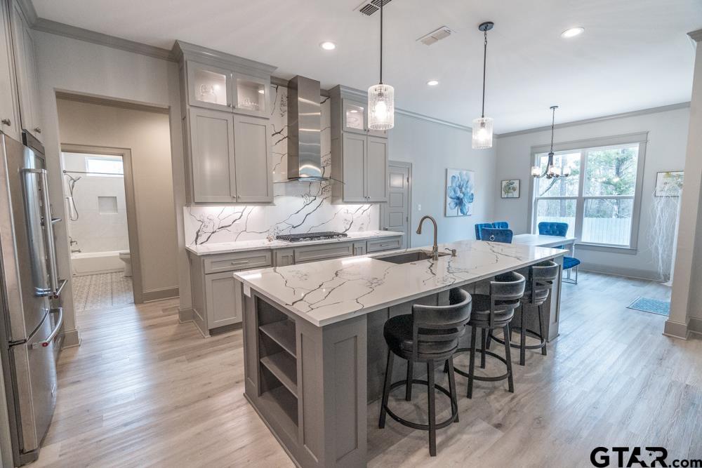 3531 Chapel View Tyler, TX 75707 - Photo 16 of 48 a kitchen with granite countertop a table chairs a sink dishwasher refrigerator and wooden floor
