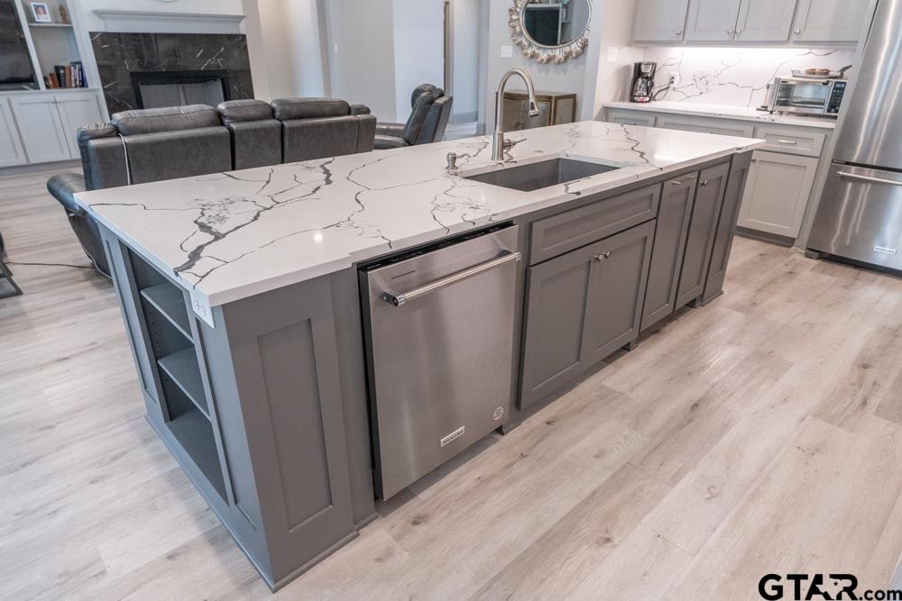 3531 Chapel View Tyler, TX 75707 - Photo 22 of 48 a kitchen with stainless steel appliances granite countertop a sink and a refrigerator
