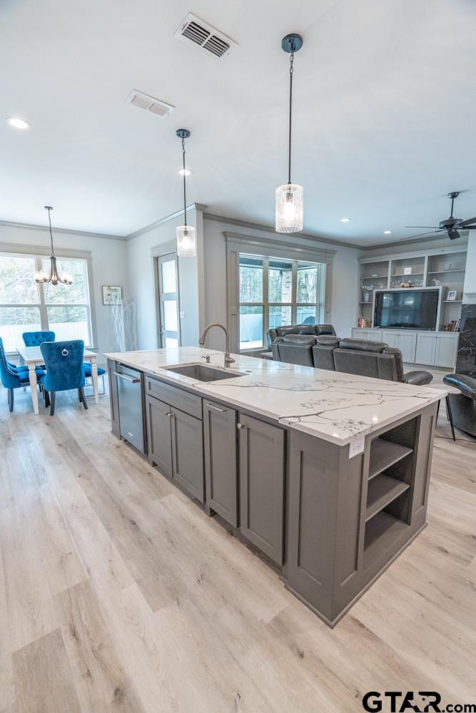 3531 Chapel View Tyler, TX 75707 - Photo 23 of 48 a large kitchen with kitchen island a stove a sink dishwasher a dining table and chairs with wooden floor