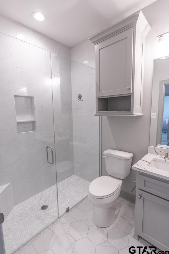 3531 Chapel View Tyler, TX 75707 - Photo 27 of 48 a white toilet sitting next to a bathroom sink