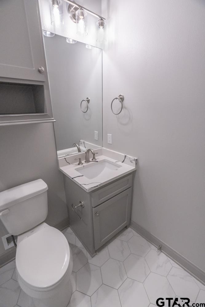 3531 Chapel View Tyler, TX 75707 - Photo 28 of 48 a bathroom with a toilet sink and mirror