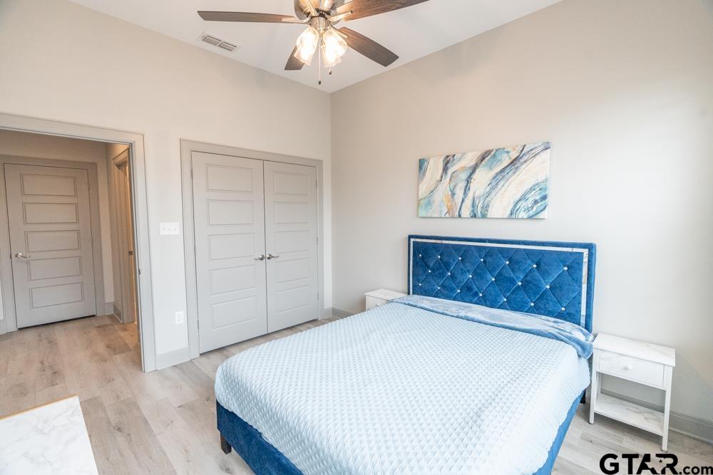 3531 Chapel View Tyler, TX 75707 - Photo 30 of 48 a bedroom with a bed and a painting on the wall