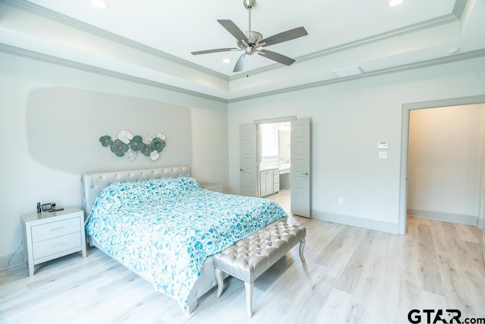 3531 Chapel View Tyler, TX 75707 - Photo 36 of 48 a bedroom with a bed and a chandelier