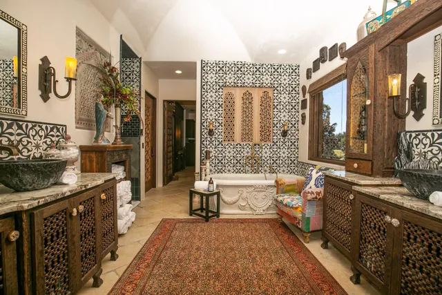 a large spacious bathroom with a tub a double vanity sink a mirror and a shower