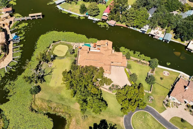 an aerial view of a house with a yard swimming pool and outdoor seating
