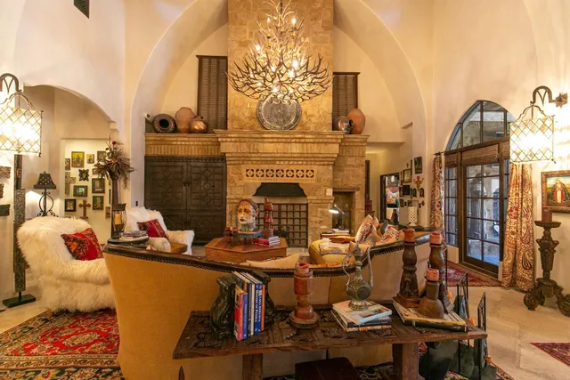 a living room with fireplace furniture and decor