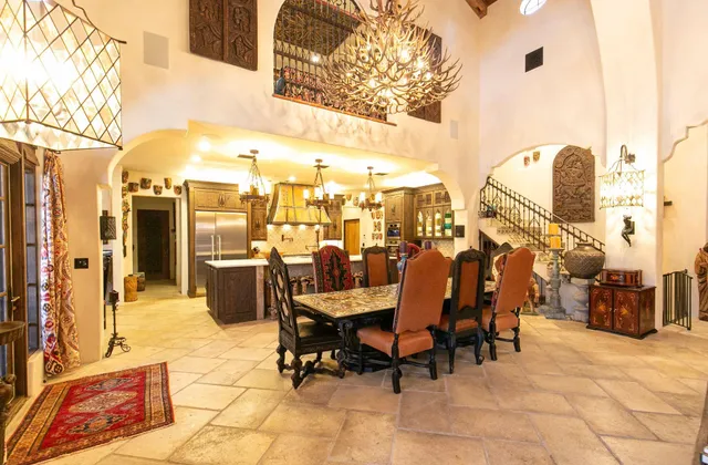 a view of a patio with dining table and chairs