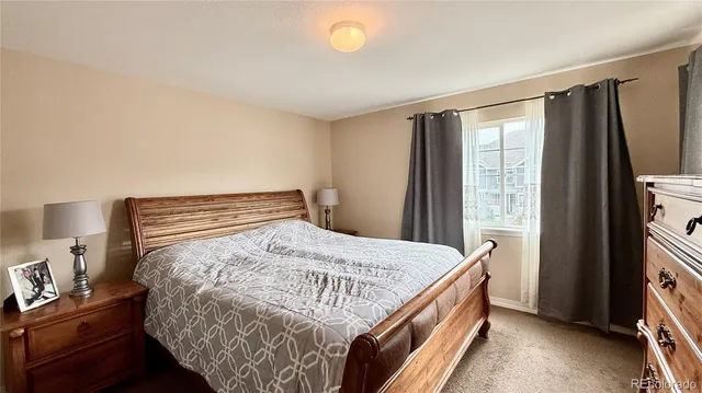 a bed sitting in a bedroom next to a window