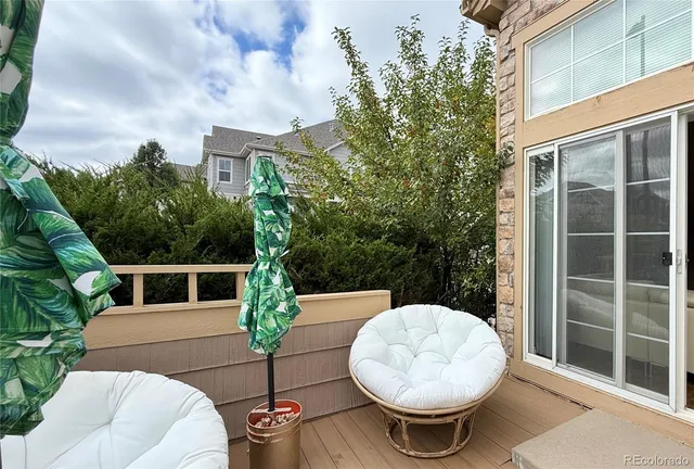a view of a balcony with table and chairs