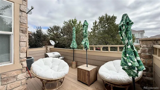 a view of a chairs and table in the back yard of the house