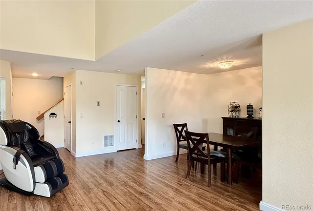 a view of a dining room with furniture and wooden floor