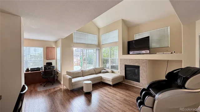 a living room with furniture fireplace and a flat screen tv