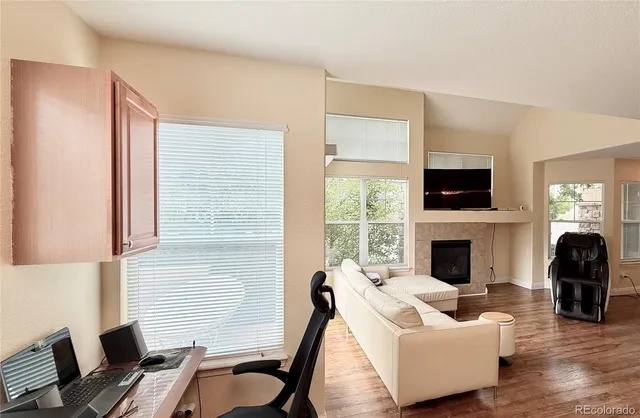 a living room with furniture a fireplace and a flat screen tv
