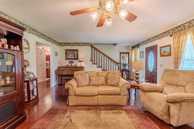 a living room with furniture and a chandelier