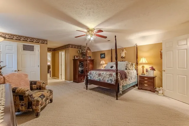 a bedroom with a bed and ceiling fan