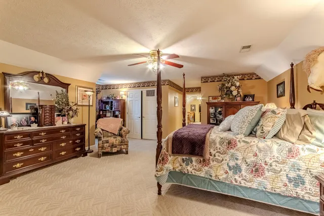 a bedroom with a bed and a large mirror