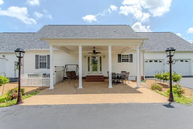 a backyard of a house with seating space and furniture
