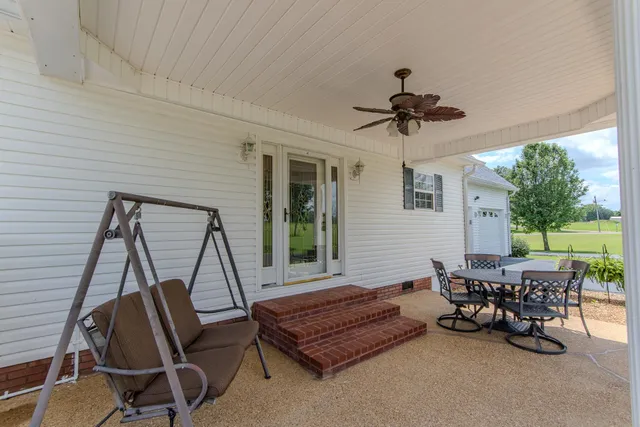 a living room with furniture a fireplace and a chandelier