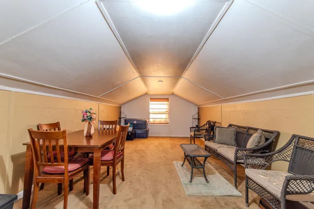 a view of a dining room with furniture and window