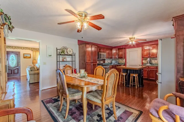 a view of a dining room with furniture wooden floor and chandelier