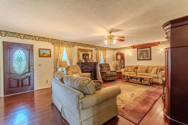 a living room with furniture and a clock