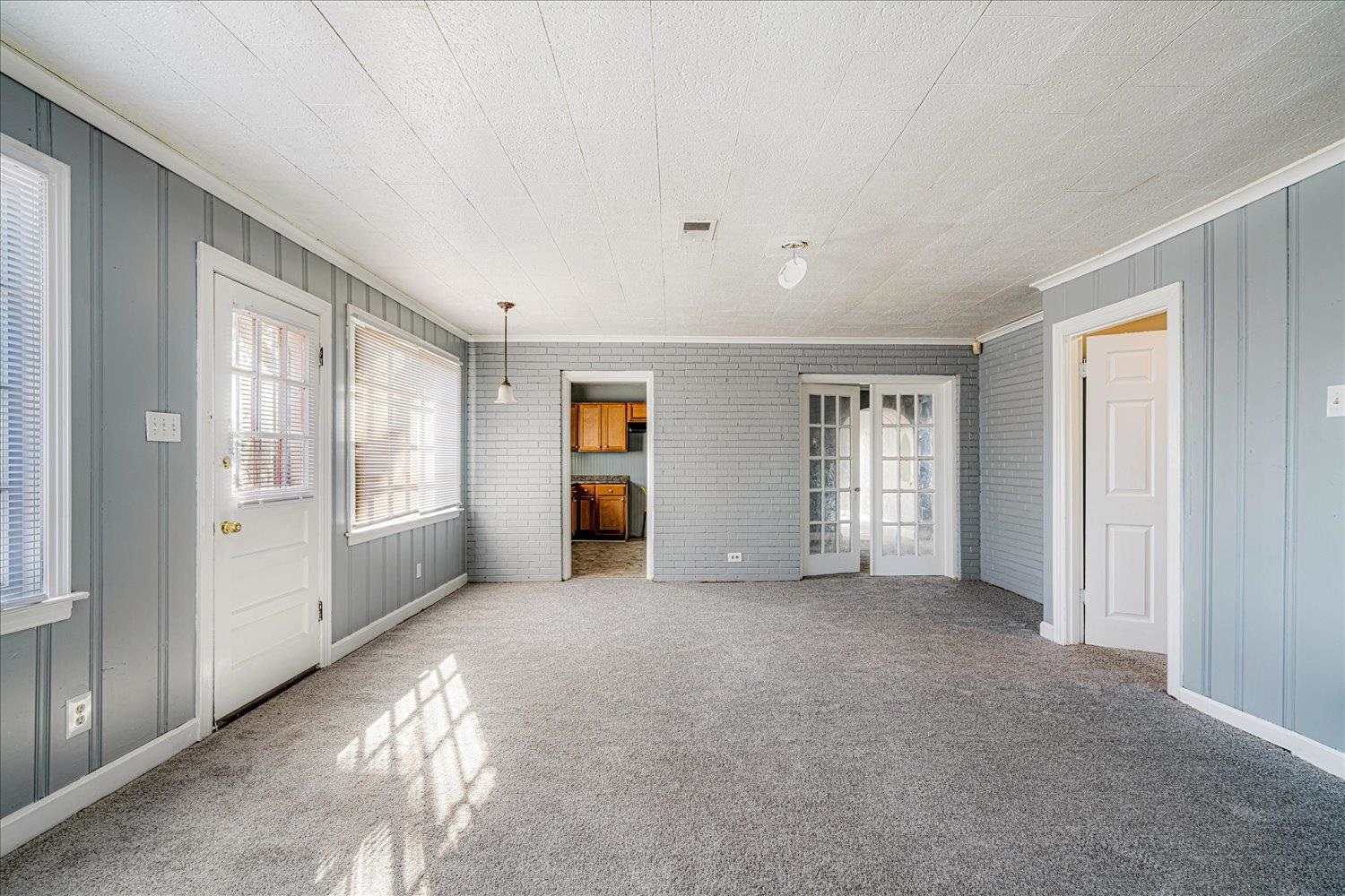 1114 Brownlee Road Memphis, TN 38116 - Photo 16 of 32 Unfurnished bedroom with multiple windows, carpet, and ornamental molding