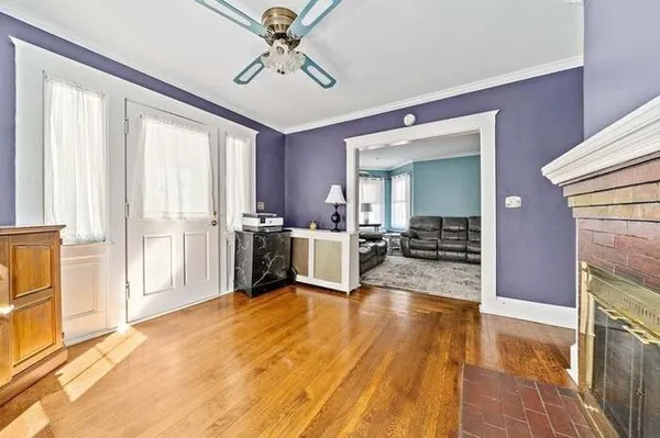 a room with wooden floor and white walls
