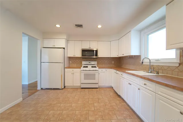 a kitchen with a refrigerator sink and microwave