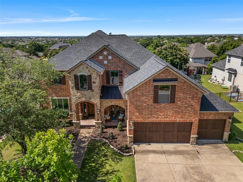 an aerial view of a house with a yard