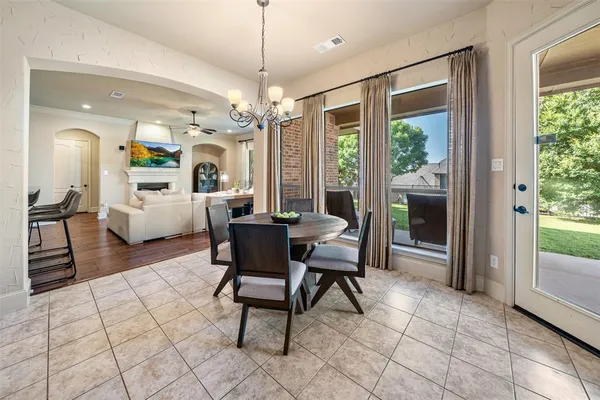 a view of a livingroom with furniture wooden floor and a chandelier