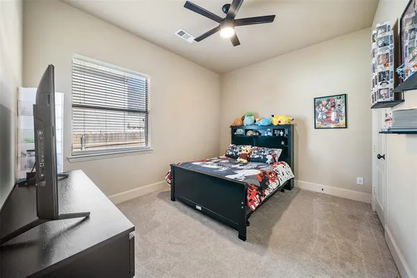 a bedroom with bed and window