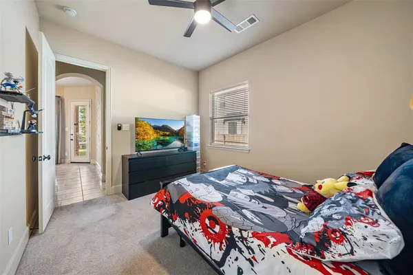 a bedroom with a bed and a chandelier