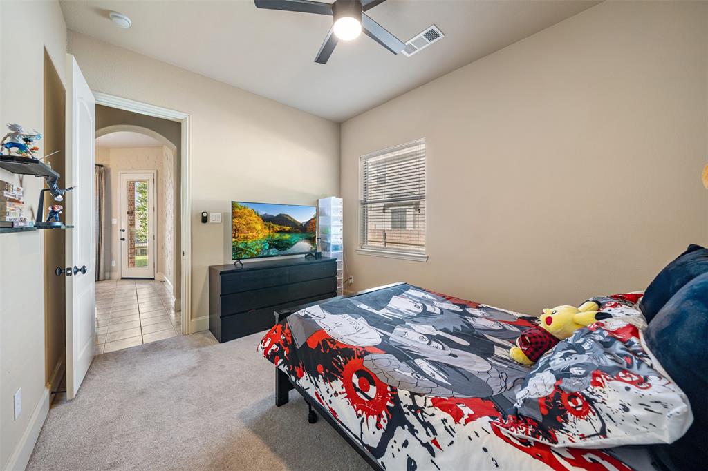 5048 Exposition Way Fort Worth, TX 76244 - Photo 13 of 39 a bedroom with a bed and a chandelier