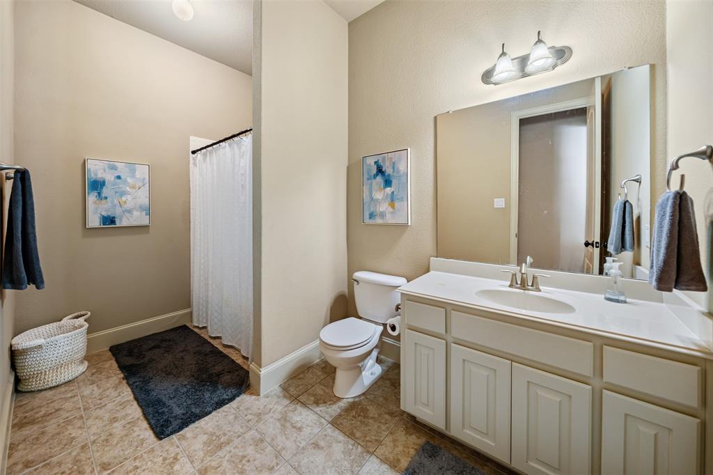5048 Exposition Way Fort Worth, TX 76244 - Photo 14 of 39 a bathroom with a toilet sink and mirror