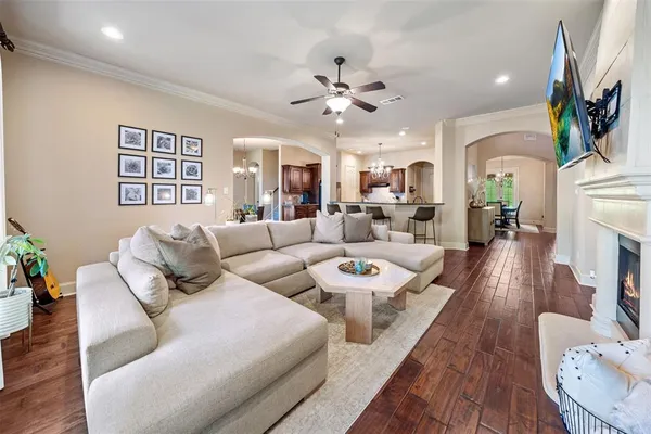 a living room with fireplace furniture and a wooden floor