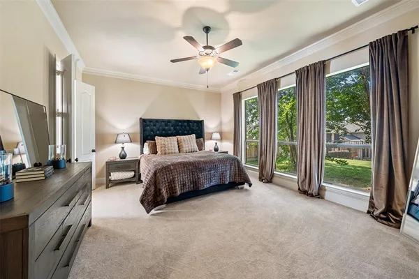 a bedroom with a bed and a large window