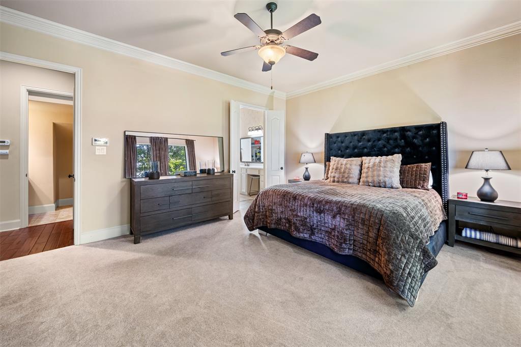 5048 Exposition Way Fort Worth, TX 76244 - Photo 17 of 39 a bedroom with a bed and a chandelier