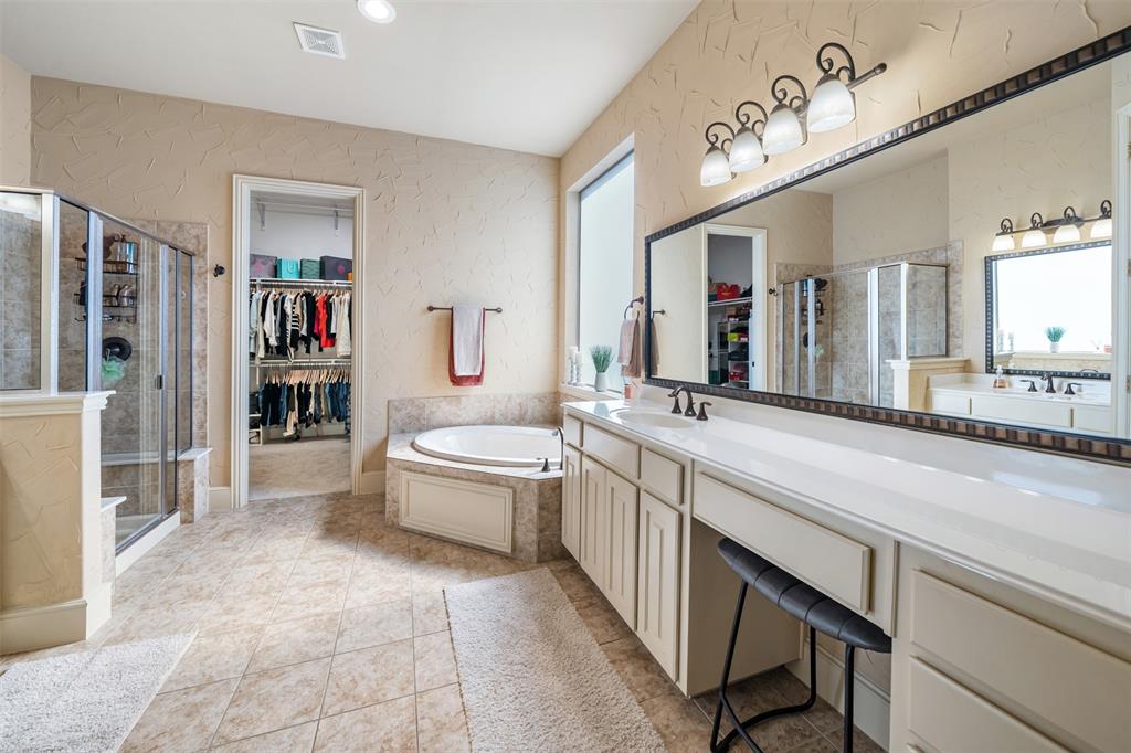 5048 Exposition Way Fort Worth, TX 76244 - Photo 18 of 39 a spacious bathroom with a granite countertop sink a mirror and a bathtub
