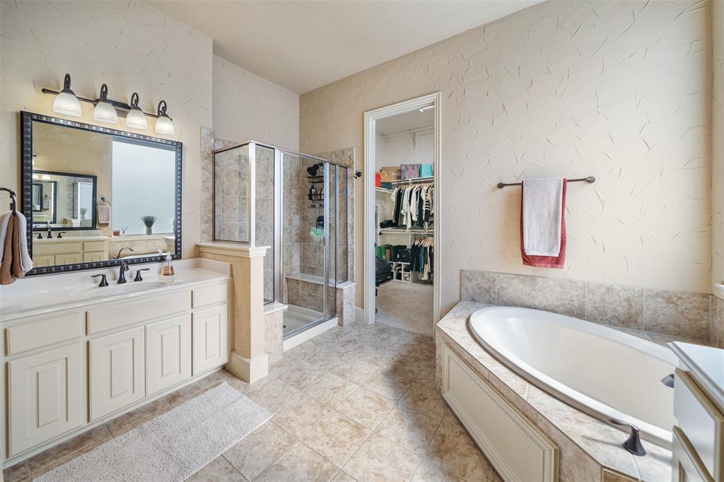 5048 Exposition Way Fort Worth, TX 76244 - Photo 19 of 39 a spacious bathroom with a granite countertop tub sink and mirror