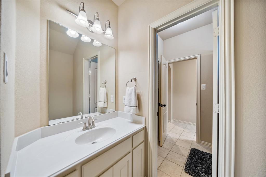 5048 Exposition Way Fort Worth, TX 76244 - Photo 25 of 39 a bathroom with a sink vanity granite and a mirror