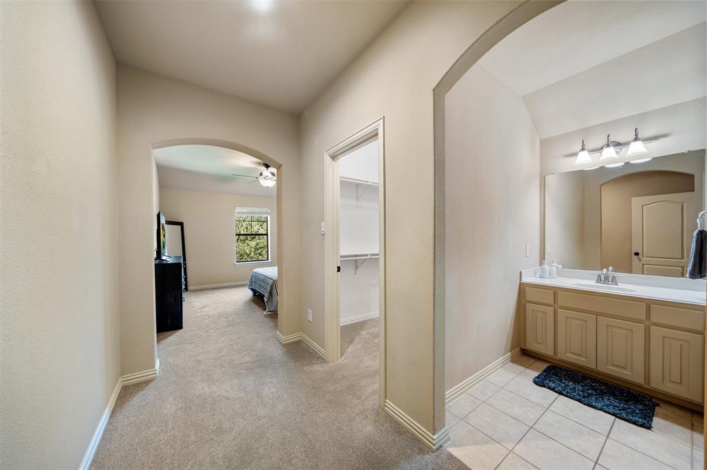 5048 Exposition Way Fort Worth, TX 76244 - Photo 27 of 39 a spacious bathroom with a double vanity sink and a mirror