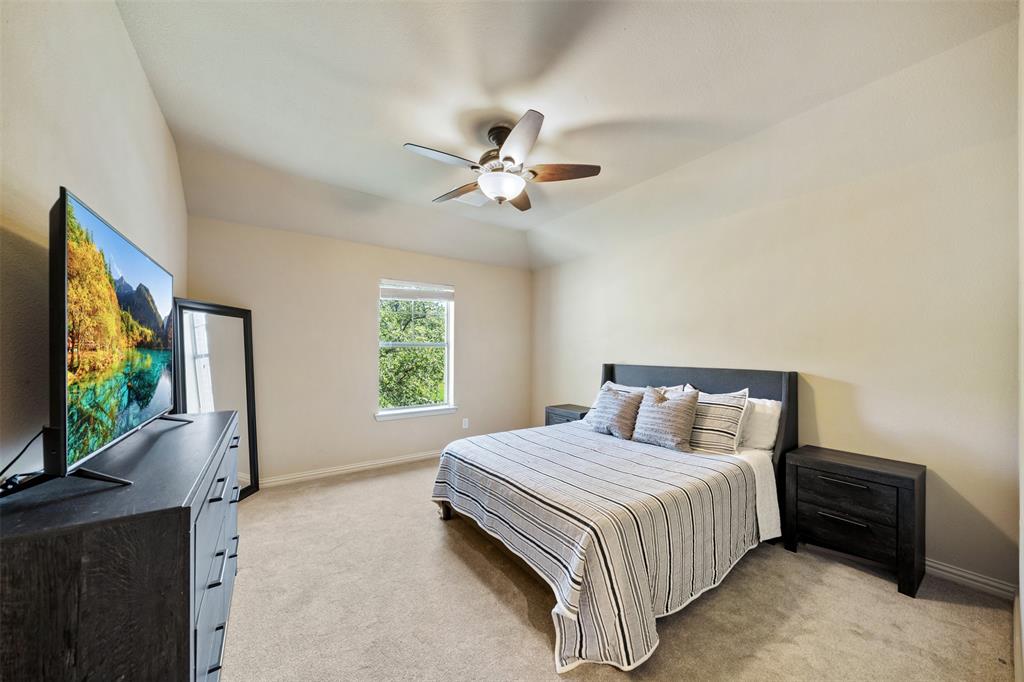 5048 Exposition Way Fort Worth, TX 76244 - Photo 28 of 39 a bedroom with a bed and a flat screen tv