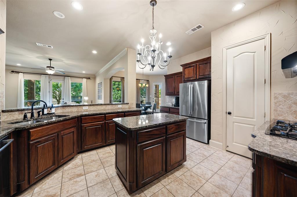 5048 Exposition Way Fort Worth, TX 76244 - Photo 9 of 39 a kitchen with granite countertop a sink stove and refrigerator