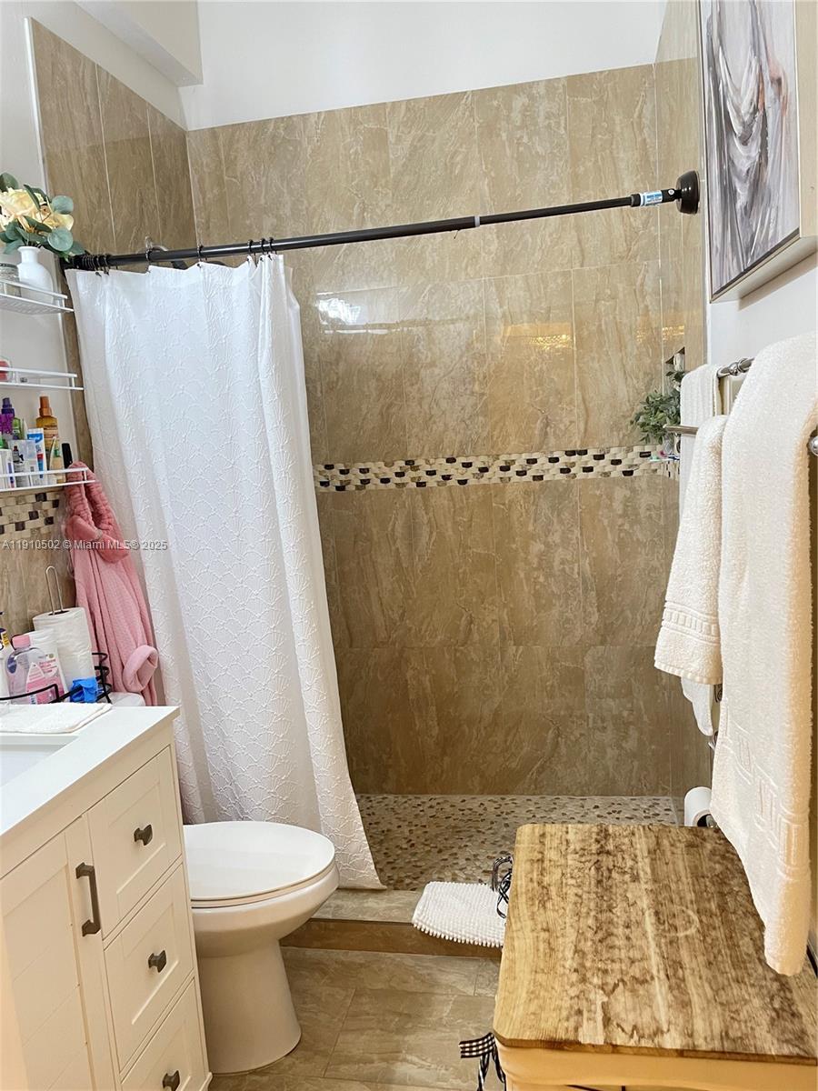 27563 Southwest 139th Place, Unit B Homestead, FL 33032 - Photo 13 of 17 a bathroom with a shower toilet and sink