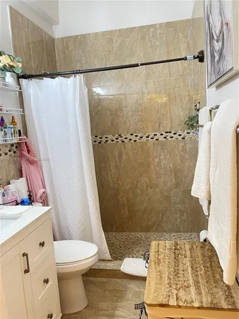 a bathroom with a shower toilet and sink